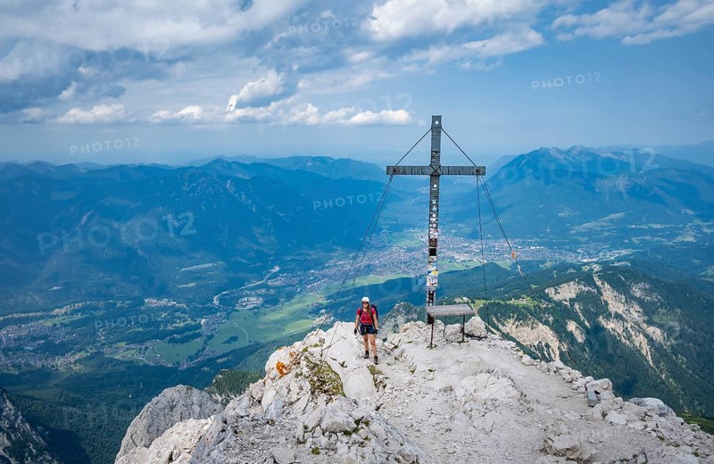 Hiker on the summit of the Alpspitze, Wetterstein range, Bavaria, Germany, Europe