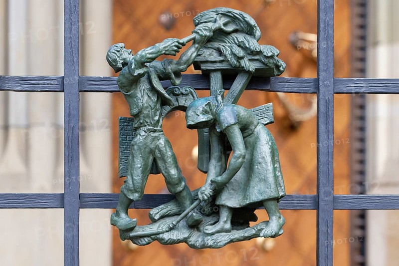 Prague castle, Gothic Metropolitan Cathedral of Saints Vitus, Wenceslas and Adalbert, Decorative figure of daily life scene on a fence, Prague, Czech Republic, Europe