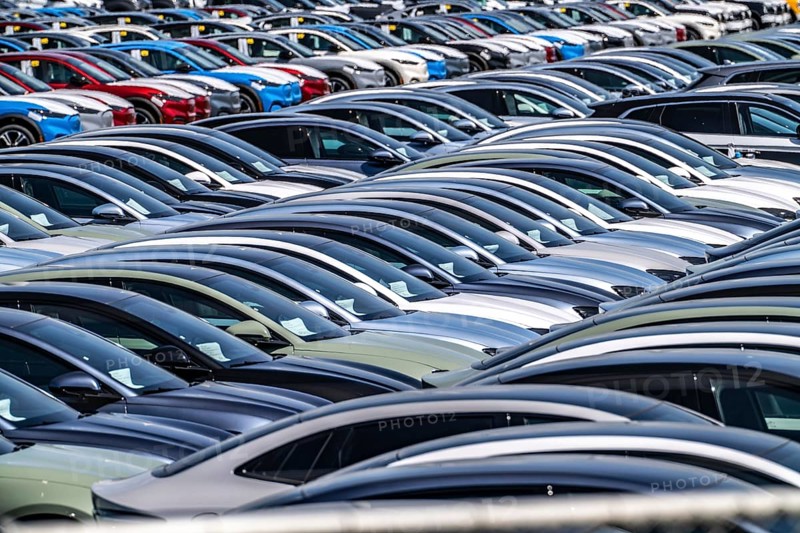 Storage area for new cars in the port of Vlissingen-Oost, vehicles are temporarily stored on over 100 hectares to ship them from Europe to the United Kingdom, Ford cars, others such as models from the Chinese car manufacturer BYD are delivered from here in Europe, wind farm, Netherlands