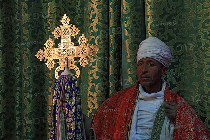 Lalibela, eastern group of rock-hewn churches, priest in the Bet Emmanuel, Emmanuel church, Ethiopian Orthodox cross, Ethiopia, Africa
