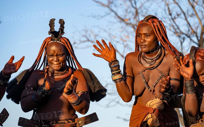 Traditional Himba woman clapping, music and dance, portraits, in the evening light, near Opuwo, Kaokoveld, Kunene, Namibia, Africa