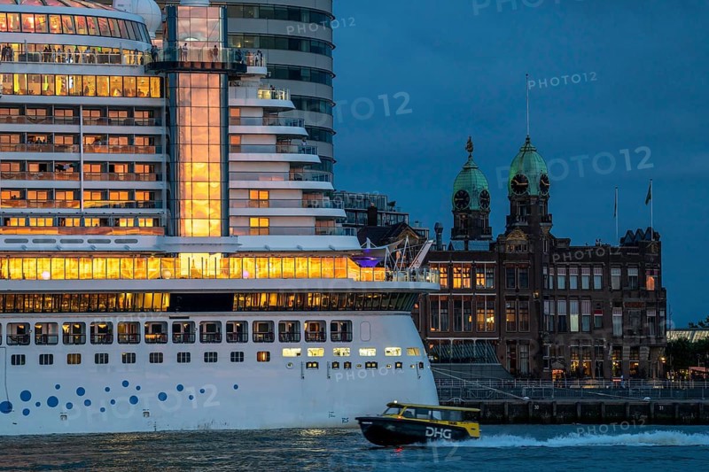 Cruise ship Aida Prima at the Cruise Terminal of Rotterdam, Kop van Zuid, skyscrapers at the Wilhelminakade, Hotel New York building, water taxi, Netherlands