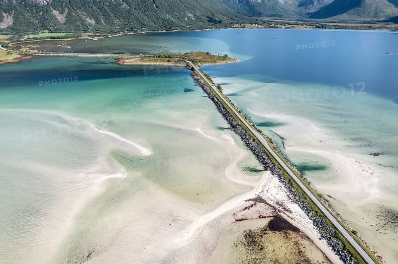Aerial view of a bridge over turquoise sea at a sandy beach, fjord Grunnforfjorden, Lofoten islands, Norway, Europe