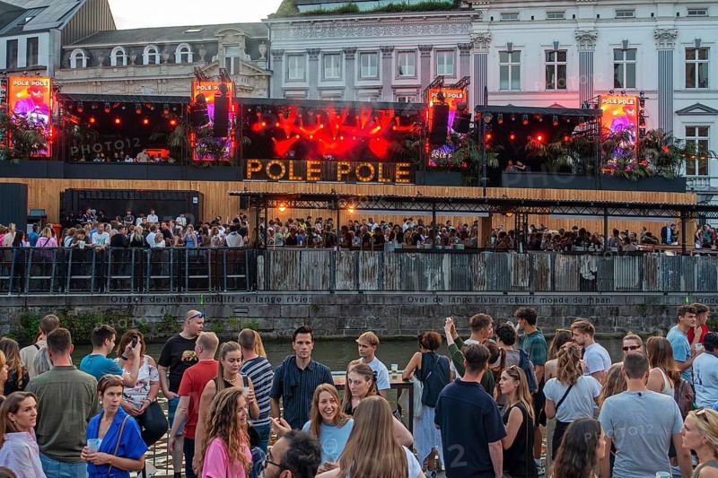Spectators on grandstand at the Graslei watching Pole Pole podium during Gentse Feesten, Ghent city festival, summer festivities in Flanders, Belgium, Europe