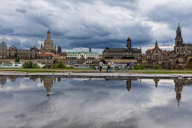 The Dresden silhouette with dark clouds behind the Church of Our Lady is reflected in a puddle on the Elbe cycle path, Elbe cycle path, Dresden, Saxony, Germany, Europe