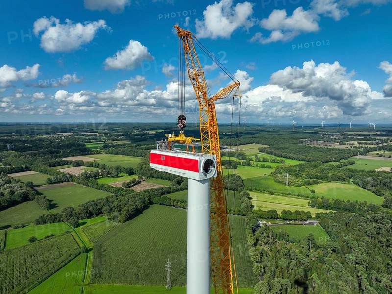 Dorsten, North Rhine-Westphalia, Germany, construction of a wind turbine, the first wind turbine of the Große Heide wind farm. A large mobile crane places the nacelle, the nacelle on the tower, Europe