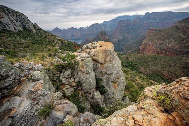 Young man on a rock, view of Blyde River Canyon with Mesa mountains, Upper Viewpoint, canyon landscape, Panorama Route, Mpumalanga, South Africa, Africa