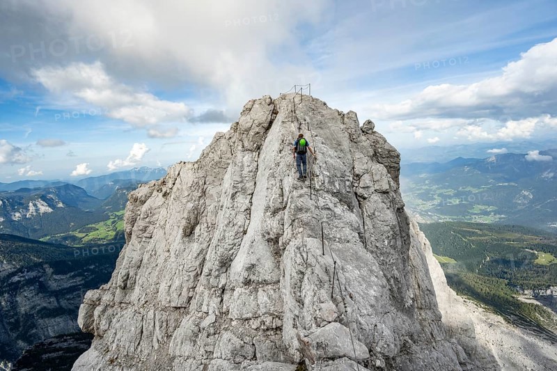 Mountaineer on a narrow rocky ridge on a steel cable, Watzmann crossing to Watzmann Mittelspitze, view of mountain panorama, Berchtesgaden National Park, Berchtesgaden Alps, Bavaria, Germany, Europe