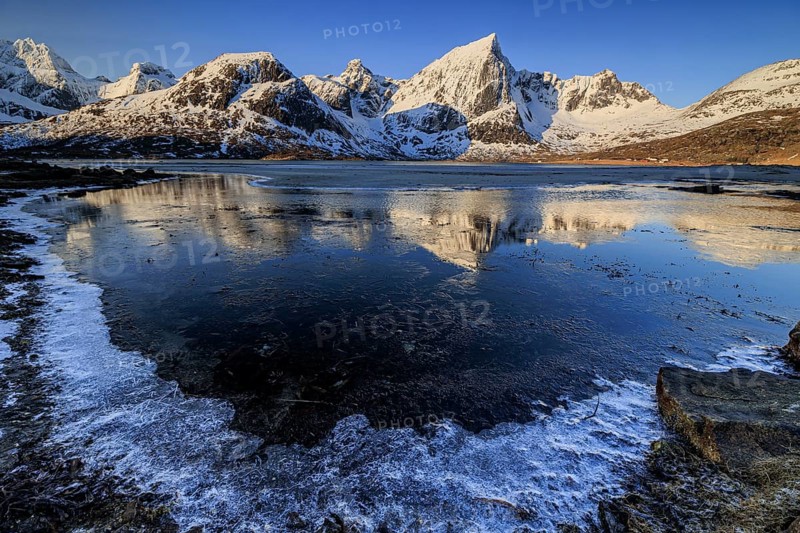 Sunrise, morning light, steep mountains and fjord, ice, winter, Flakstadoya, Lofoten, Norway, Europe