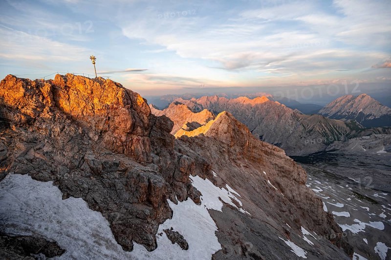 Summit of the Zugspitze with golden summit cross, alpenglow at sunset, Northern Limestone Alps, Wetterstein Mountains, Bavaria, Germany, Europe
