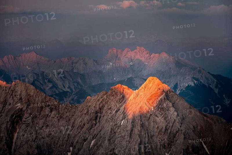Last light on rocky mountains, Impressive rocky mountain landscape, Steep mountain ridge, Jubiläumsgrat with Alpspitze, Mountain panorama from the summit of the Zugspitze, Alpenglow at sunset, Northern Limestone Alps, Wetterstein range, Bavaria, Germany, Europe