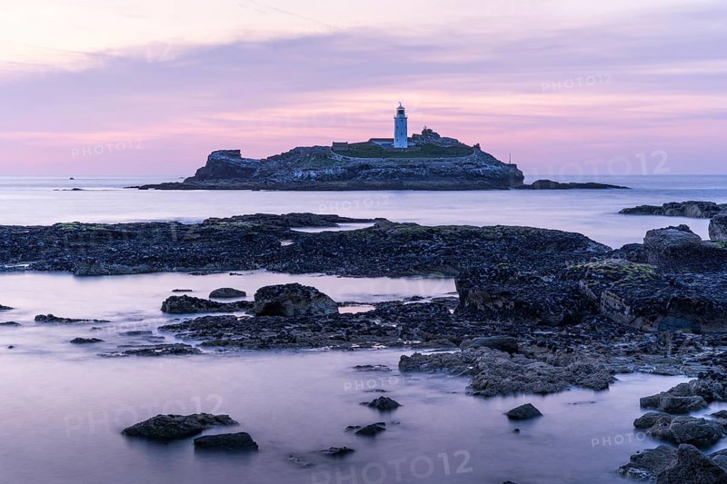 Godrevy Lighthouse, the lighthouse of Godrevy on Godrevy Island. In the evening at sunset. Long exposure. Cornwall, England, Great Britain