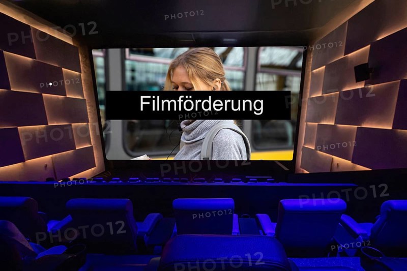 Symbolic image of film funding: FILMFÖRDERUNG text on the screen in a cinema (composing)