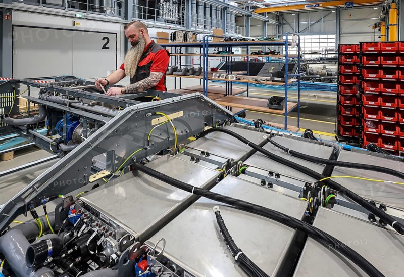 Herten, North Rhine-Westphalia, Germany, Cummins Hydrogenics fuel cell factory. An employee assembles fuel cell systems for Alstom's Coradia iLint hydrogen trains. The Coradia iLint is the world's first passenger train to be powered by a hydrogen fuel cell, which generates electrical energy for propulsion. Six fuel cell modules are installed in each train (right in the picture) . Note: The person pictured has given their verbal consent for publication in the press, Europe