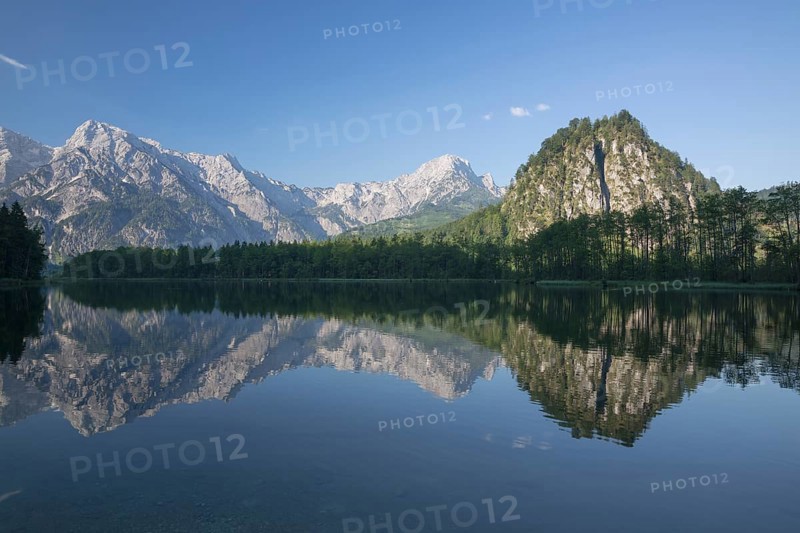 Lake Almsee in summer with totally smooth surface showing reflexion of the mountain Ameisstein