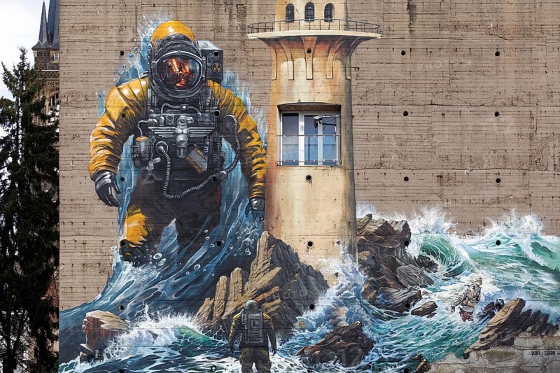 Astronaut standing in surf, mural on the subject of climate change on a bunker, by street art artist duo Tubuku, Krefeld, North Rhine-Westphalia, Germany, Europe
