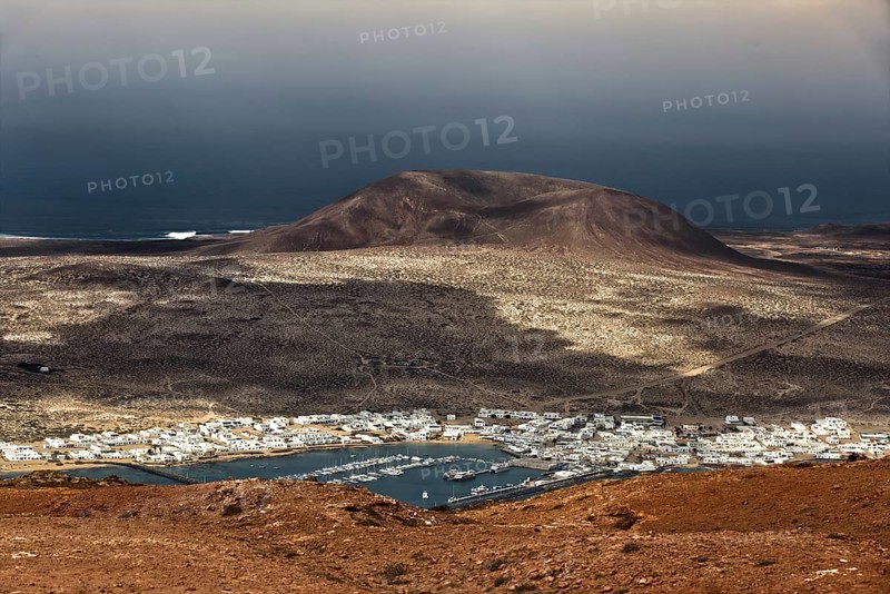 View from the Mirador del Rio, a viewpoint in the north of Lanzarote, down to the neighbouring island of La Graciosa, under a cloudy sky, Lanzarote, Canary Islands, Spain, Europe