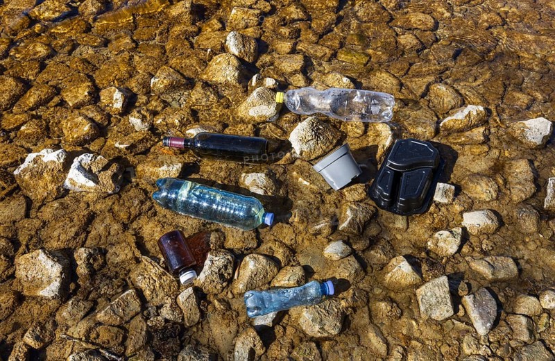 Environmental pollution, Household waste washed up on the lake shore, Plastic and glass bottles, Austria, Europe