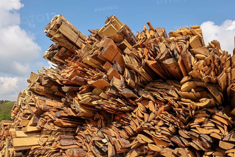 Solingen, North Rhine-Westphalia, Germany - Residual wood in the timber store of a sawmill is processed into wood chips and used as fuel in a combined heat and power plant, construction timber is scarce and expensive, carpentry and joinery companies are struggling with rapidly rising raw timber prices in times of the corona crisis, large quantities of logs are exported to China and the USA