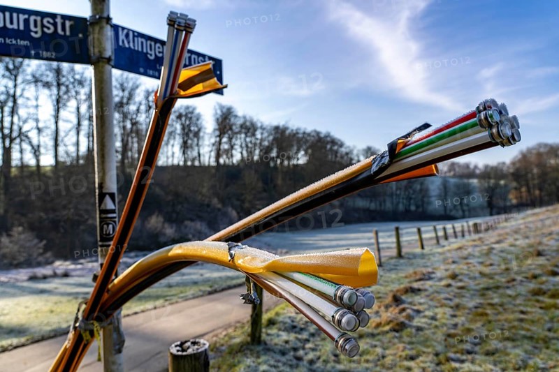 Fibre optic connection, empty conduits protrude from the ground along a dirt track, into which the actual fibre optic cable is later blown and connected to the respective house connection or distributor, provision of fast Internet in rural areas, in the south of Mülheim an der Ruhr, North Rhine-Westphalia, Germany, Europe