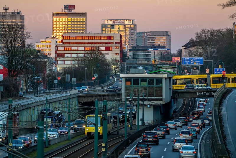 Motorway A40, Ruhr expressway, heavy traffic jam, rush hour, city passage in Essen, skyline of the city centre, underground line between the lanes, tram, Hobeisenbrücke stop, North Rhine-Westphalia, Germany, Europe