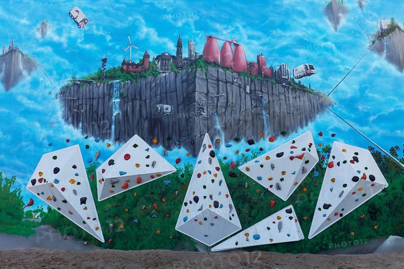 Climbing wall with surreal mural, flying city, by artist duo TUBUKU, Voltaplatz skate park, Krefeld, North Rhine-Westphalia, Germany, Europe