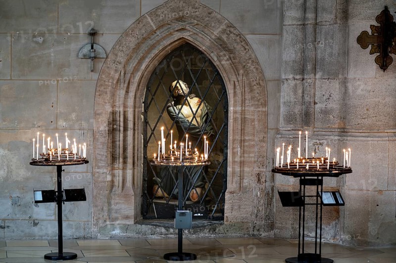 Sacrificial candles, behind them in the niche a figure of Jesus in the late Gothic hall church of St George, Dinkelsbühl, Bavaria, Germany, Europe