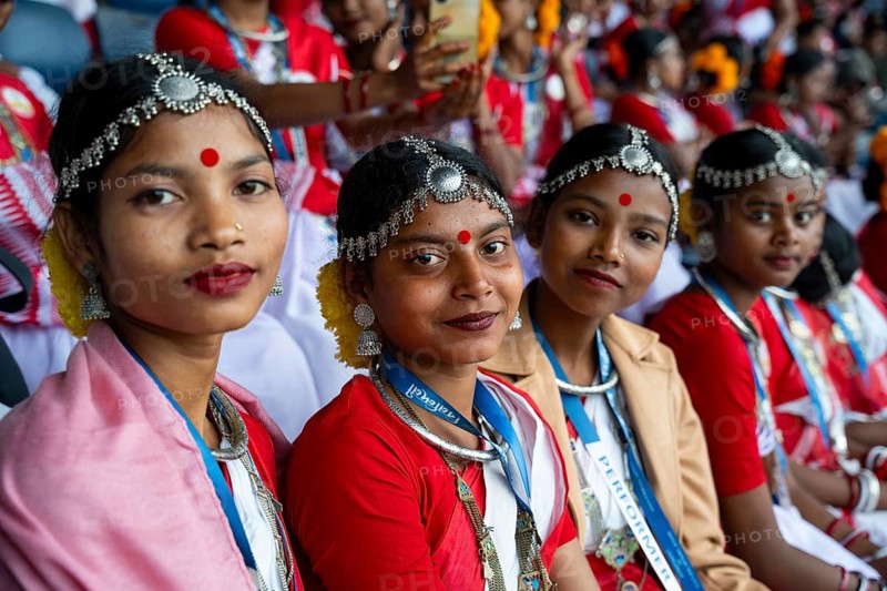 Girls from tea tribe community wearing traditional attire, wait to perform traditional Jhumur dance, on the eve of 'Jhumoir Binandini' event at the Sarusajai Stadium in Guwahati, India on February 23, 2025. Jhumur Dance is a traditional folk dance popular in Assam, West Bengal, Jharkhand, and Odisha, mainly performed by the Adivasi (Tea Tribe) community and other indigenous groups