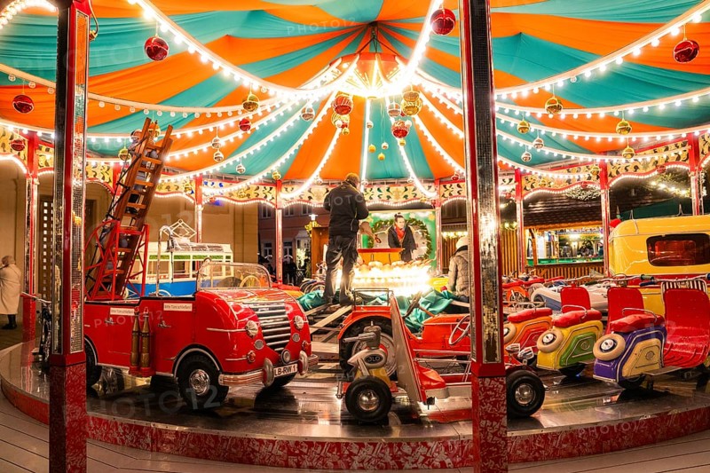 A colourful carousel with fairy lights in a lively night-time atmosphere, Ludwigsburg Christmas Market, Germany, Europe