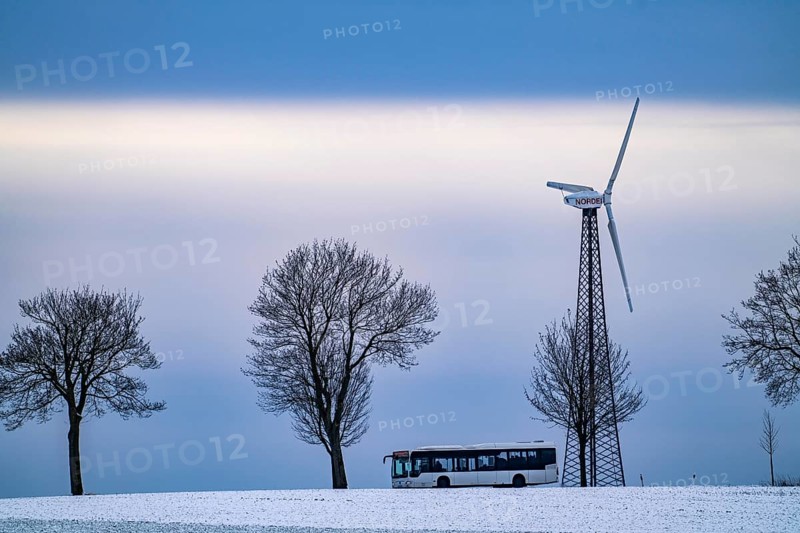 Country road, local train, wind farm, north of Lichtenau, self-proclaimed energy town, over 190 wind turbines and over 1200 solar panels generate 10 times as much electricity as the community of 11, 900 inhabitants consumes, largest onshore cluster of wind turbines in Germany, winter, slightly snow-covered landscape, North Rhine-Westphalia, Germany, Europe