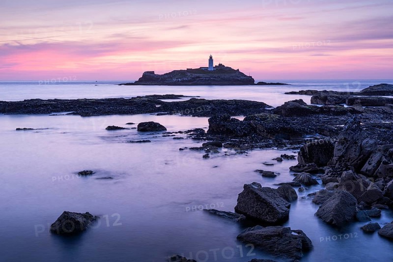 Godrevy Lighthouse, the lighthouse of Godrevy on Godrevy Island. In the evening at sunset. Long exposure. Cornwall, England, Great Britain