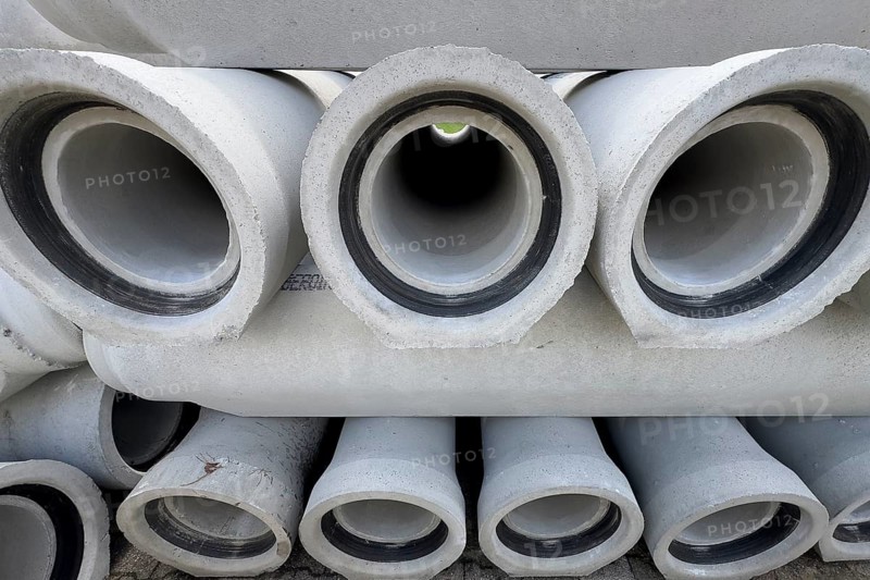 Stacked concrete pipes Sewer pipes for laying Pipe laying in road construction for sewage Rainwater Industrial water, symmetrical graphic photo, Germany, Europe