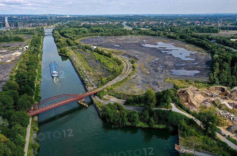 Essen, North Rhine-Westphalia, Germany - FREIHEIT EMSCHER urban development project. The cities of Essen and Bottrop, together with the owner RAG Montan Immobilien GmbH, want to transform former mining sites on the Rhine-Herne Canal and Emscher into an urban centre with commerce and industry, residential areas as well as green spaces and leisure facilities on the waterfront. The so-called nucleus, consisting of the Sturmshof site (left) on the Bottrop side of the Rhine-Herne Canal and the Coelln-Neuessen harbour (right) on the Essen side, plays a special role here
