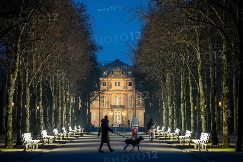 The light benches by artist Stefan Sous in the Hofgarten, entitled UV-A UV-B, 14 completely refurbished exhibits from the 2002 light-grey art exhibition, which now stand and light up as a permanent work of art on Jägerhofallee, LED technology, in the background Jägerhof Palace, home of the Goethe Museum, Düsseldorf, North Rhine-Westphalia, Germany, Europe