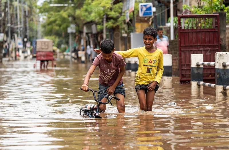 Children wade through a flooded street after heavy rains in Guwahati, India on April 28, 2025