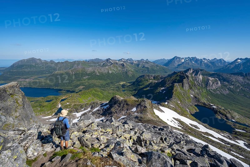 View of mountains and fjord landscape, mountain panorama, mountaineer at the summit of Rundfjellet, lake Hellskarvatnet, Svolvaer, Nordland, Norway, Europe