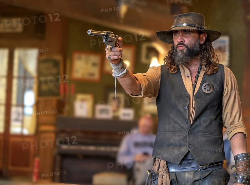 Western actor (sheriff with colt) in the saloon of the western village Fort Bravo or Texas Hollywood, Almeria, Spain, Europe
