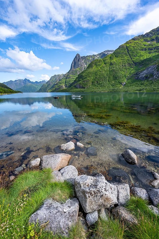Small boats at the fjord Austnesfjorden, idyllic Norwegian fjord landscape, mountains reflected in the water, Sildpollen, Nordland, Norway, Europe