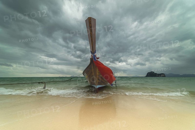 Longtail boat on the beach, dark rain clouds behind, Koh Ngai Island, Andaman Sea, Satun Province, Southern Thailand, Thailand, Asia