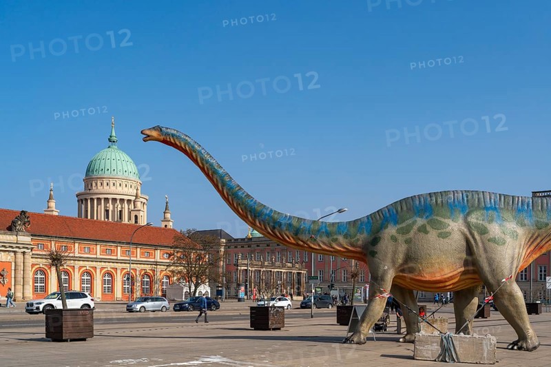 Large figure of a brontosaurus from a dinosaur exhibition in front of the film museum in the historic Marstall and the dome of the Nikolaikirche, Potsdam, Brandenburg