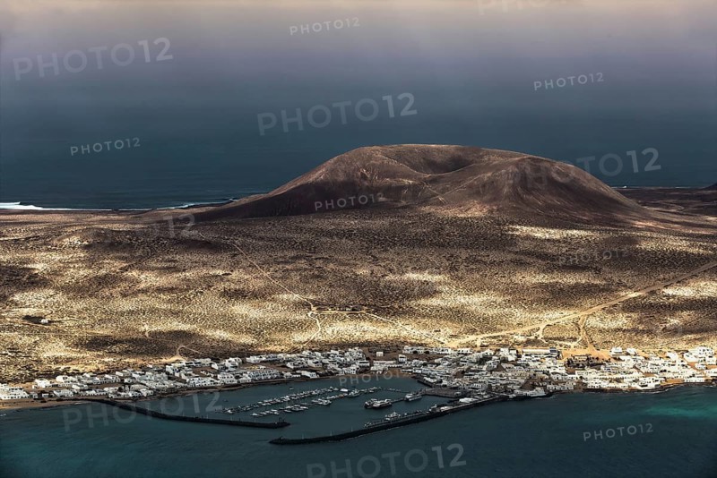 View from the Mirador del Rio, a viewpoint in the north of Lanzarote, down to the neighbouring island of La Graciosa, under a cloudy sky, Lanzarote, Canary Islands, Spain, Europe