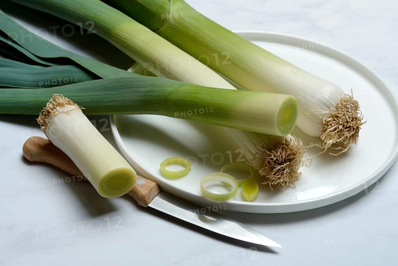 Leek, leek sticks on plate with knife, leek
