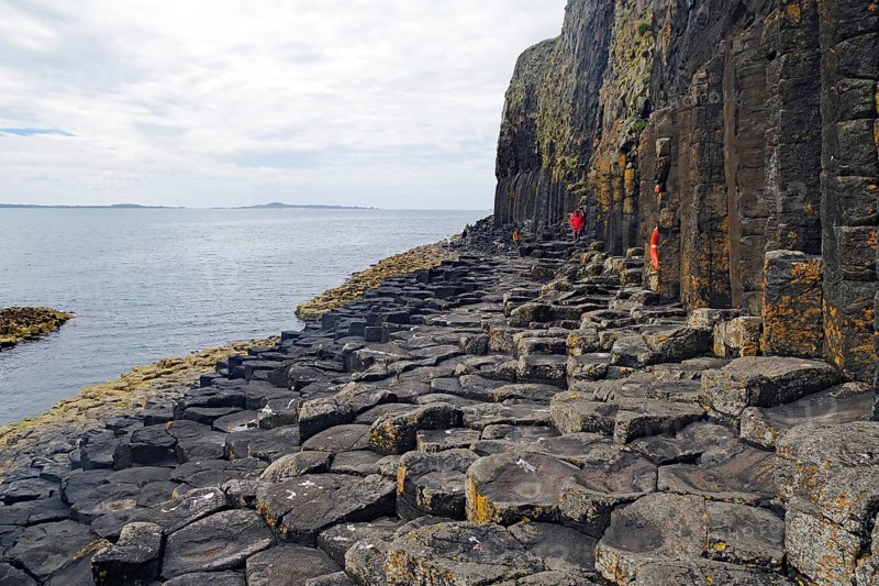 Majestic rock formation with basalt columns on a rugged coastline by the sea, Staffa, Hebrides, Scotland, United Kingdom, Europe