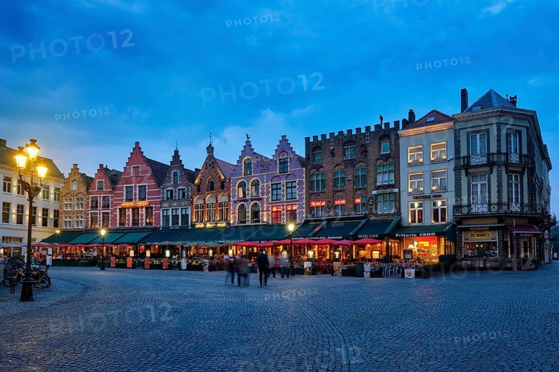 Bruges, Belgium, May 29, 2018: Bruges Grote markt square famous tourist place with many cafe and restaurants in the evening night twilight, Europe