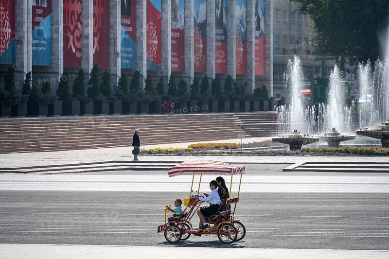 Family in a rickshaw on Ala-Too Square, in Bishkek, Kyrgyzstan, Asia