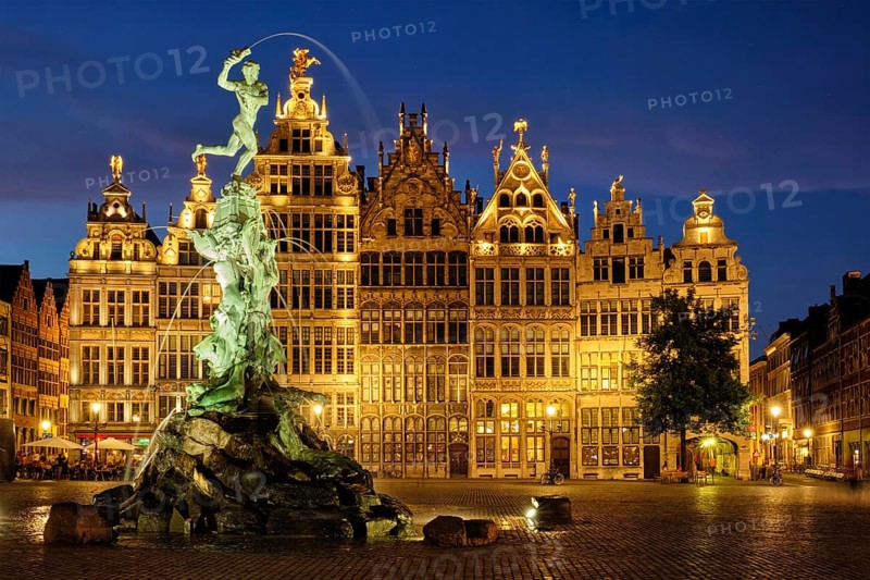 Antwerp famous Brabo statue and fountain on Grote Markt square illuminated at night and old houses. Antwerp, Belgium, Europe