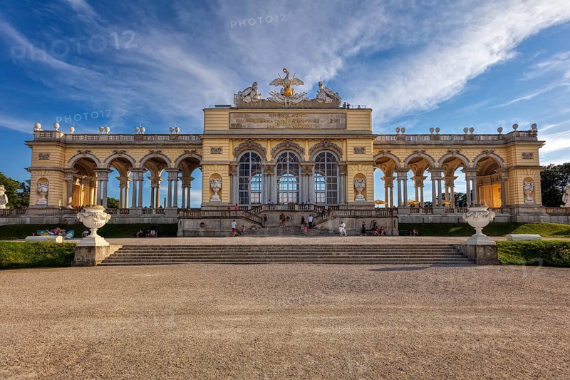 A majestic gloriette with decorative elements and visitors, Vienna
