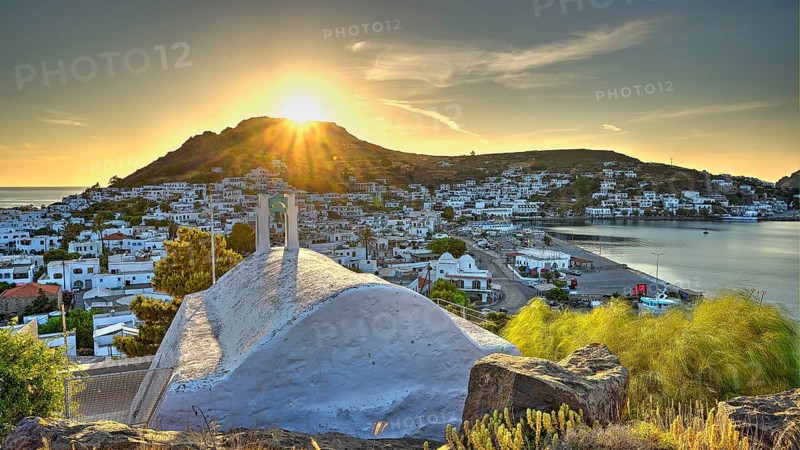 Agia Paraskevi Chapel, Small chapel at sunset with a view of a coastal town and the sea in the background, Skala, Patmos, Dodecanese, Greek Islands, Greece, Europe