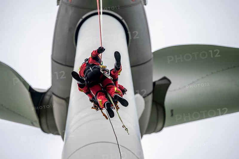 Height rescuers from the Gelsenkirchen fire brigade practise abseiling from a wind turbine from a height of 110 metres after rescuing an accident victim from the nacelle, Gladbeck, North Rhine-Westphalia, Germany, Europe