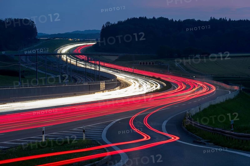 Tracers on the A8 motorway, winding road, evening, long exposure, Swabian Alb, Baden-Württemberg, Germany, Europe